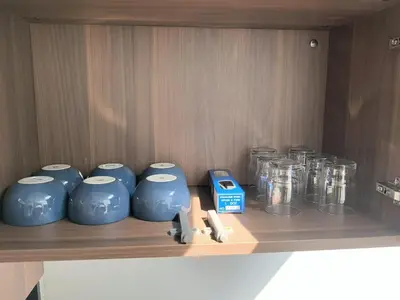 a row of blue vases on a wooden shelf at 150 square meters 3BR with parking townhouse near golf course, UWC school, Nayang Beach, airport in Ban Muang Mai (1)