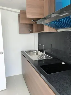 a kitchen with a sink and a black counter top at 150 square meters 3BR with parking townhouse near golf course, UWC school, Nayang Beach, airport in Ban Muang Mai (1)