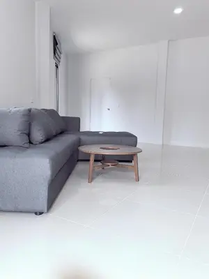 a living room with a couch and a coffee table at 150 square meters 3BR with parking townhouse near golf course, UWC school, Nayang Beach, airport in Ban Muang Mai (1)