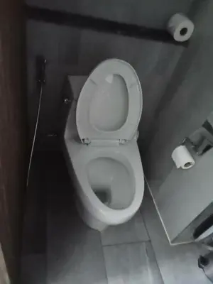 a bathroom with a toilet with two rolls of toilet paper at Palmyrah Surin Beach Residence in Surin Beach