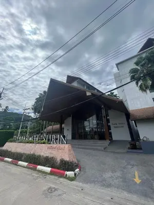 a building with a black awning in front of it at Palmyrah Surin Beach Residence in Surin Beach
