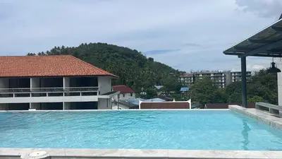 a large swimming pool in front of a building at Palmyrah Surin Beach Residence in Surin Beach