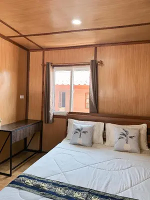 a bedroom with a large bed with a window at Friendly house in Ko Phlong