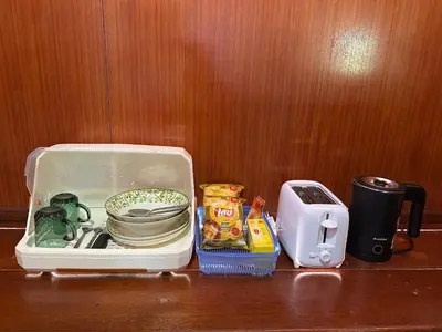 a lunch box sitting on a table next to a toaster at Friendly house in Ko Phlong