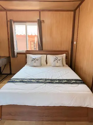 a large bed in a room with a window at Friendly house in Ko Phlong