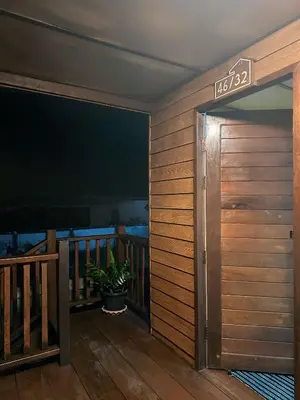 an open door to a balcony with a television at Friendly house in Ko Phlong