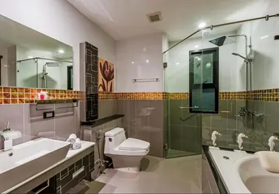 a bathroom with a toilet and a sink and a shower at Chalong Miracle Lakeview in Chalong