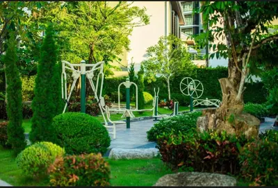 a garden with a park with a playground at Chalong Miracle Lakeview in Chalong