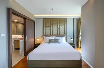 a bedroom with a large bed and a bathroom at Private Residents in Surin Mida in Surin Beach