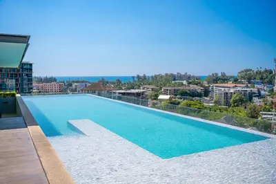 a swimming pool on the roof of a building at Private Residents in Surin Mida in Surin Beach