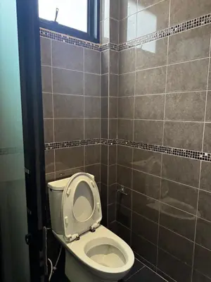 a bathroom with a toilet with the seat up at Pool villa Phuket in Kata Beach