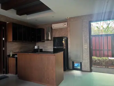 a kitchen with a counter and a refrigerator at Pool villa Phuket in Kata Beach