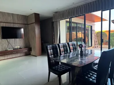 a dining room with a table and leather chairs at Pool villa Phuket in Kata Beach