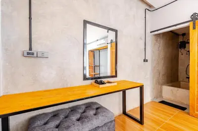 a dressing room with a mirror and a wooden table at Cactus Villa 2024 in Klong Muang Beach