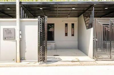 an open door of a white building with a staircase at Cactus Villa 2024 in Klong Muang Beach