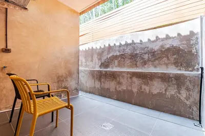 a yellow chair in a room with a window at Cactus Villa 2024 in Klong Muang Beach
