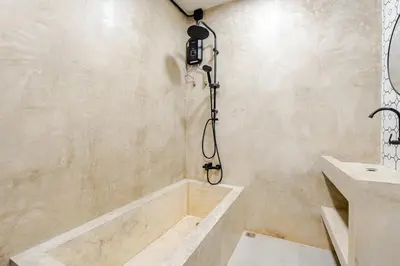 a bathroom with a tub and a sink at Cactus Villa 2024 in Klong Muang Beach