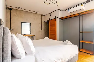 a bedroom with a large bed with white pillows at Cactus Villa 2024 in Klong Muang Beach