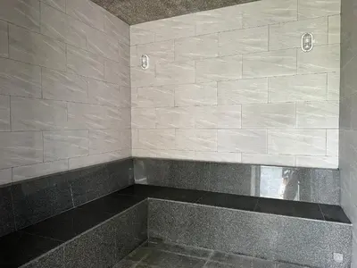 a tiled shower with a bench in a bathroom at Title Halo Romantic Suite Pool View Gym in Nai Yang Beach