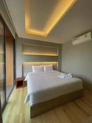 a bedroom with a large bed with white sheets at Prime Location46 sqm Room, King-Size Bed in Ao Nang Beach