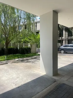 a white pillar in a parking lot with a car at Prime Location46 sqm Room, King-Size Bed in Ao Nang Beach