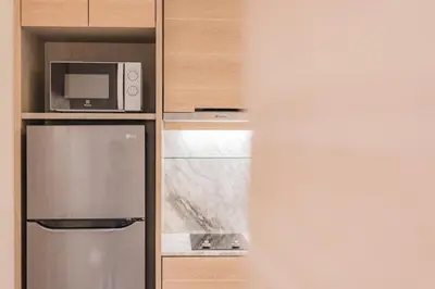 a kitchen with a refrigerator and a microwave at Luxury sea view apartments in Ao Nang Beach