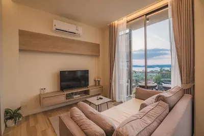 a living room with a couch and a flat screen tv at Luxury sea view apartments in Ao Nang Beach