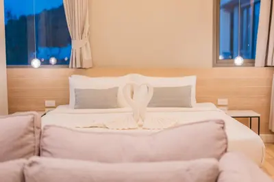 a bedroom with a bed and a couch with a ribbon at Luxury sea view apartments in Ao Nang Beach