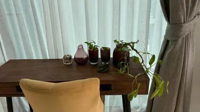 a wooden table with vases and plants on it at Patong Sea View pool view condo in Patong Beach