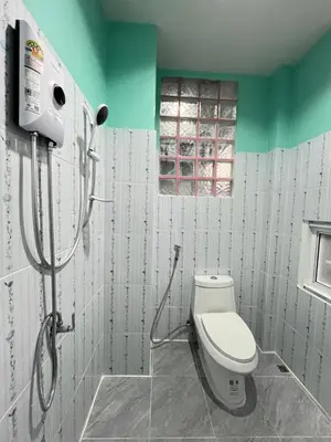 a bathroom with a toilet and a shower at Boonyawat Apartment in Kata Beach