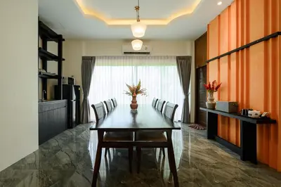 a dining room with a table and chairs and a window at Noppharat Krabi Resort in Ao Nang Beach