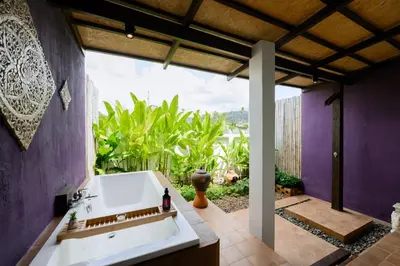 a bathroom with a sink and a large window at Noppharat Krabi Resort in Ao Nang Beach
