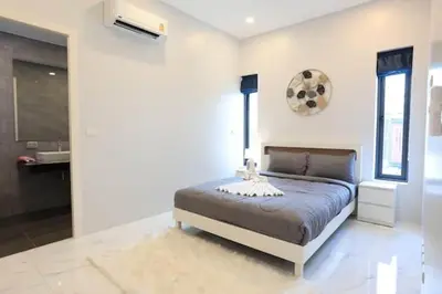 a bedroom with a bed and a clock on the wall at V150 5-Star Villa Perfect for Relaxation &Comfort in Rawai Beach