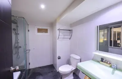 a bathroom with a shower and a toilet and a sink at Ocean and Mountainviews, 2 Balconies in Patong Beach