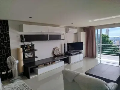 a living room with a kitchen with a stove at Ocean and Mountainviews, 2 Balconies in Patong Beach