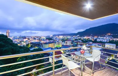 a balcony with a table and chairs overlooking a city at Ocean and Mountainviews, 2 Balconies in Patong Beach