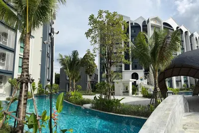 a swimming pool with palm trees in front of a building at JU1 NEW Halo Nayang Руб ВАТСАП669З582I976 in Nai Yang Beach