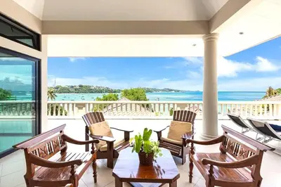 a porch with chairs and a table with a view of the ocean at 10 - Panoramic View on Ao Yon Beach in Ko Thanan