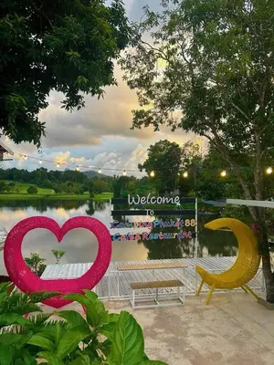 a heart shaped sign in front of a lake at Camping Phuket 88 in Kathu