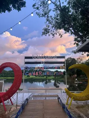 a sign in front of a lake with two chairs at Camping Phuket 88 in Kathu
