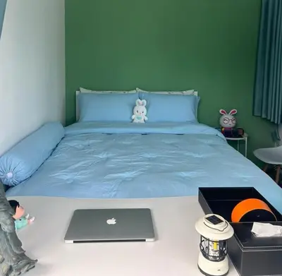 a bedroom with a bed with a laptop on it at Camping Phuket 88 in Kathu