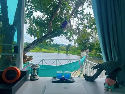 a hammock on a table with a view of a river at Camping Phuket 88 in Kathu
