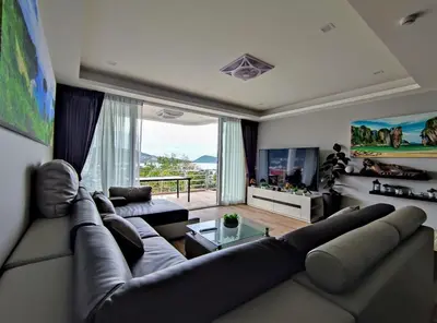 a living room with a large couch and a large window at Sawansa 34B 475m2 Luxury Sea view pool near beach in Patong Beach