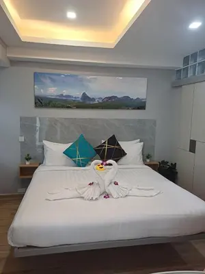 a bedroom with a white bed with towels on it at Sawansa 34B 475m2 Luxury Sea view pool near beach in Patong Beach