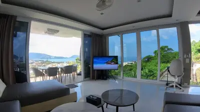 a living room with a couch and a tv at Sawansa 33A 400m2 Luxury Seaview Pool near Beach in Patong Beach