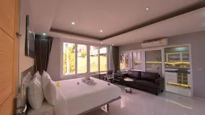 a large bedroom with a large bed and a couch at Sawansa 33A 400m2 Luxury Seaview Pool near Beach in Patong Beach