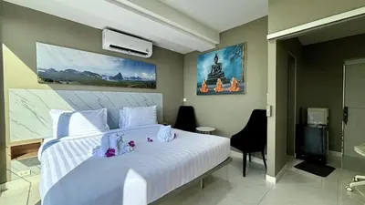 a bedroom with a large white bed and a bathroom at Sawansa 33A 400m2 Luxury Seaview Pool near Beach in Patong Beach