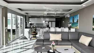 a living room with a couch and a kitchen at Sawansa 33B 425m2 Luxury Seaview Pool near Beach in Patong Beach