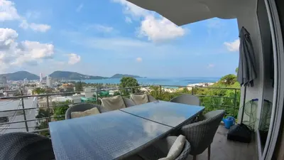 a table and chairs on a balcony with a view at Sawansa 33B 425m2 Luxury Seaview Pool near Beach in Patong Beach
