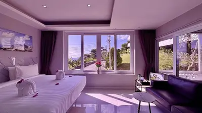 a bedroom with a large bed and a large window at Sawansa 33B 425m2 Luxury Seaview Pool near Beach in Patong Beach